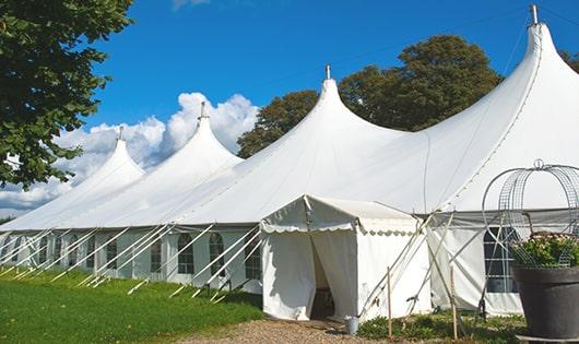 tall green portable restrooms assembled at a music festival, contributing to an organized and sanitary environment for guests in Bullard